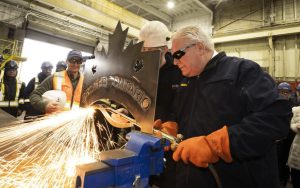 Ontario Progressive Conservative Leader Doug Ford uses a torch to cut some steel during a visit to Heddle Shipyard in St. Catharines, Ont. on Friday, Jan. 31, 2025. The engraving in the steel says "Protect Ontario." THE CANADIAN PRESS/Peter Power